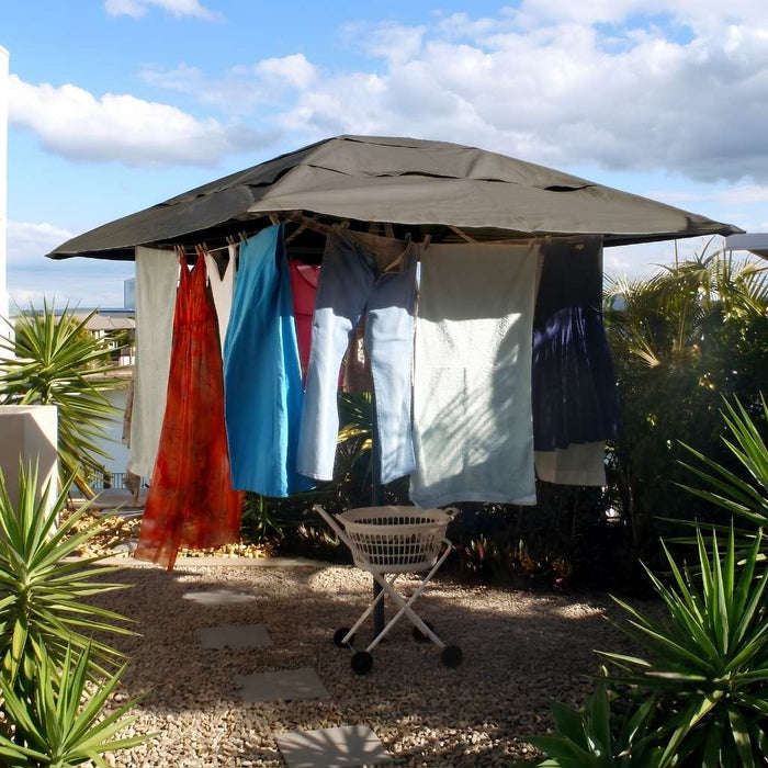 ClevaCover Rotary Clothesline Cover on a Hills Folding Rotary Hoist Clothesline.  Outside in a garden with washing hanging from the clothesline cord.