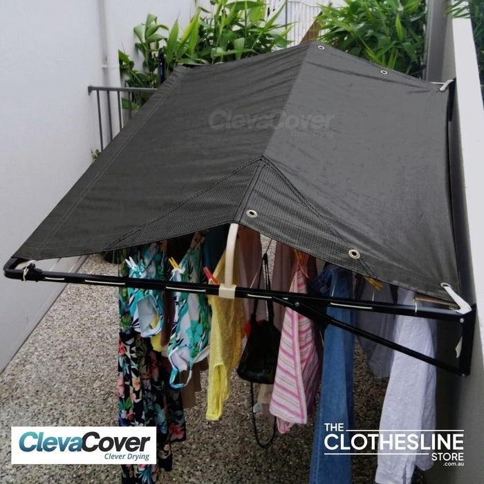 Clothesline installed on a rendered wall with washing hung on the lines.  Cover fully extended.