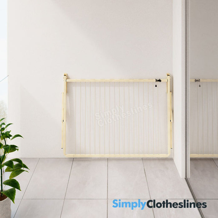 Austral Balcony Line clothesline colour Classic Cream and folded flat position against an external balcony wall of an apartment
