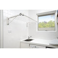 Austral Indoor Outdoor fold down clothesline, colour is surfmist, installed on a white tiled laundry room wall above a sink.
