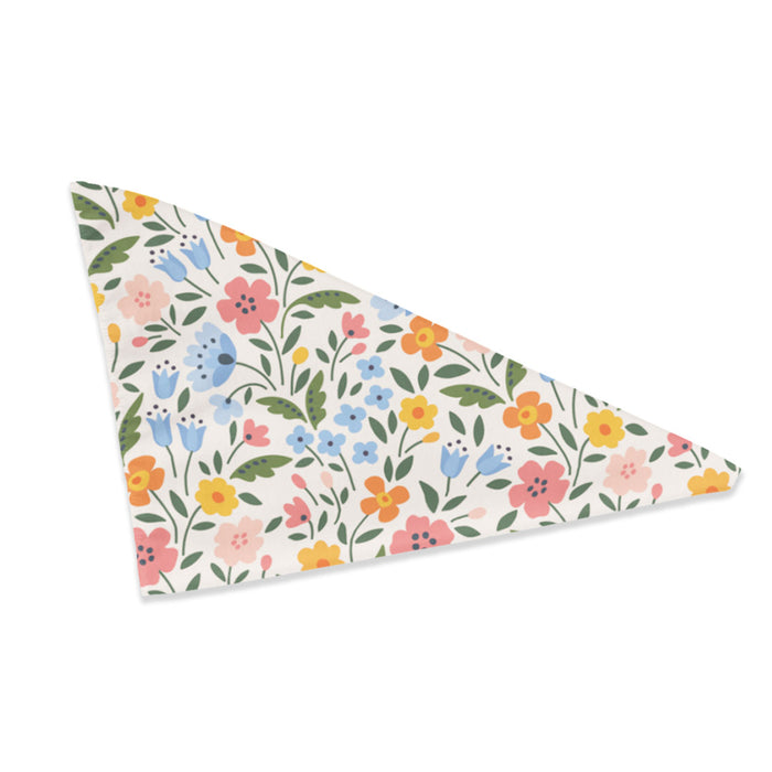 Triangle dog bandana with pink, blue, orange, and yellow floral print on cream fabric.