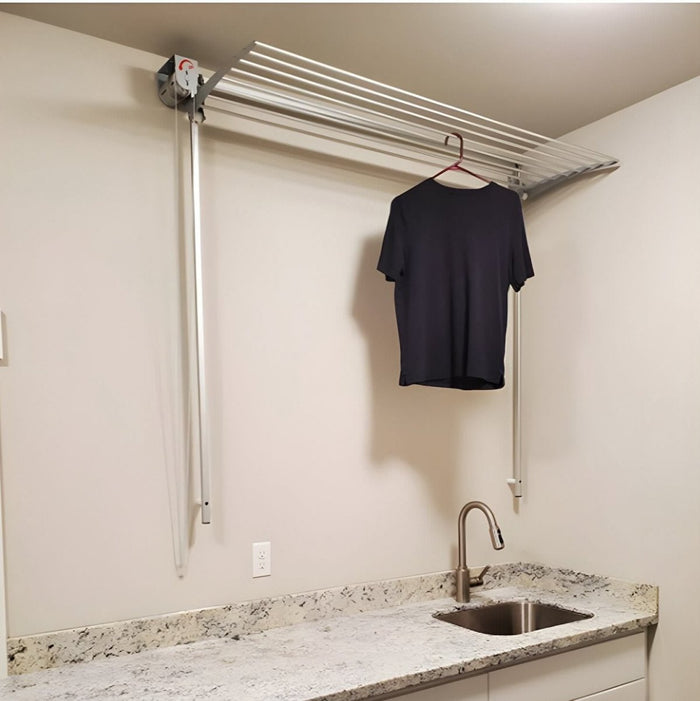 FoxyDry Wall wall mounted drying rack installed near window for airflow – ideal apartment laundry solution.