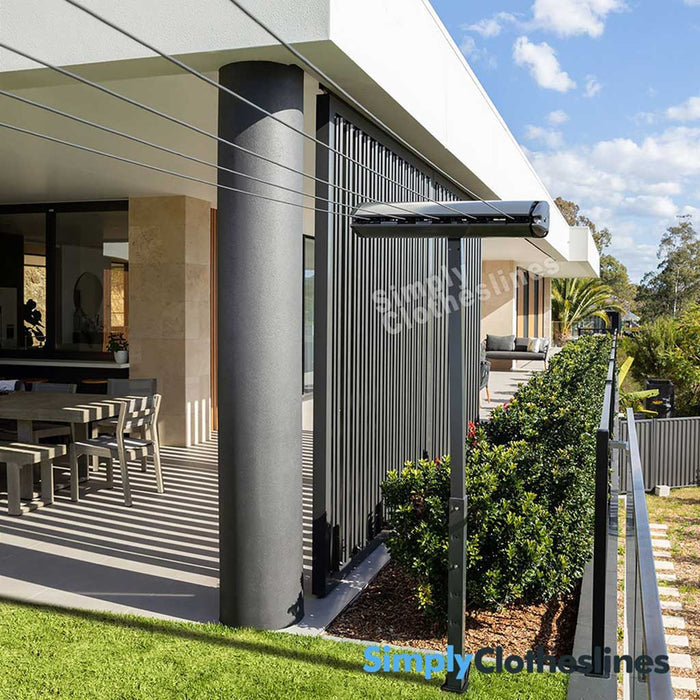 Hills Retractable 5 Line clothesline installed in a courtyard setting using a post mount kit for installation.
