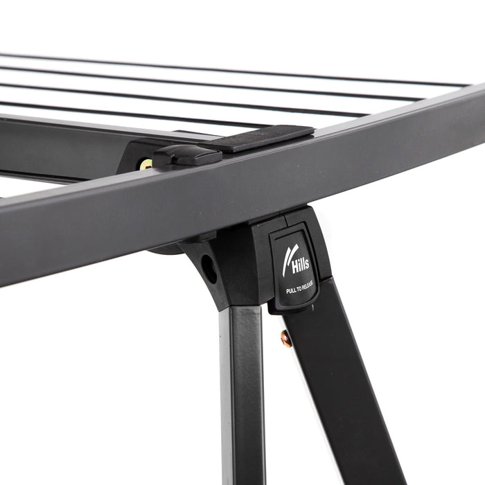 Close-up of the line lever with words pull to release - to open and fold down the portable clothesline.