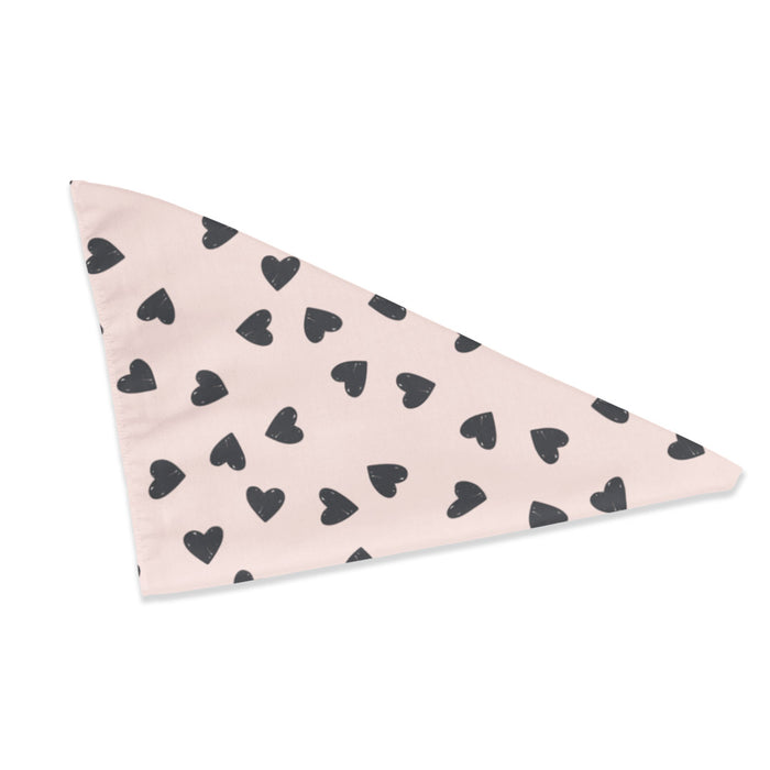 Pink triangle dog bandana with hand-drawn black hearts printed across the fabric.