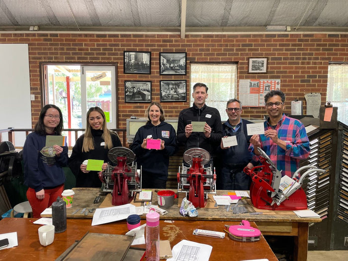 Six participants proudly showing off their freshly printed prints