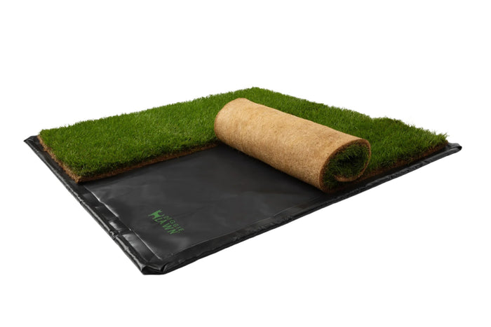 DoggieLawn real grass pad partially rolled up on a black flex tray showing the coconut coir backing.
